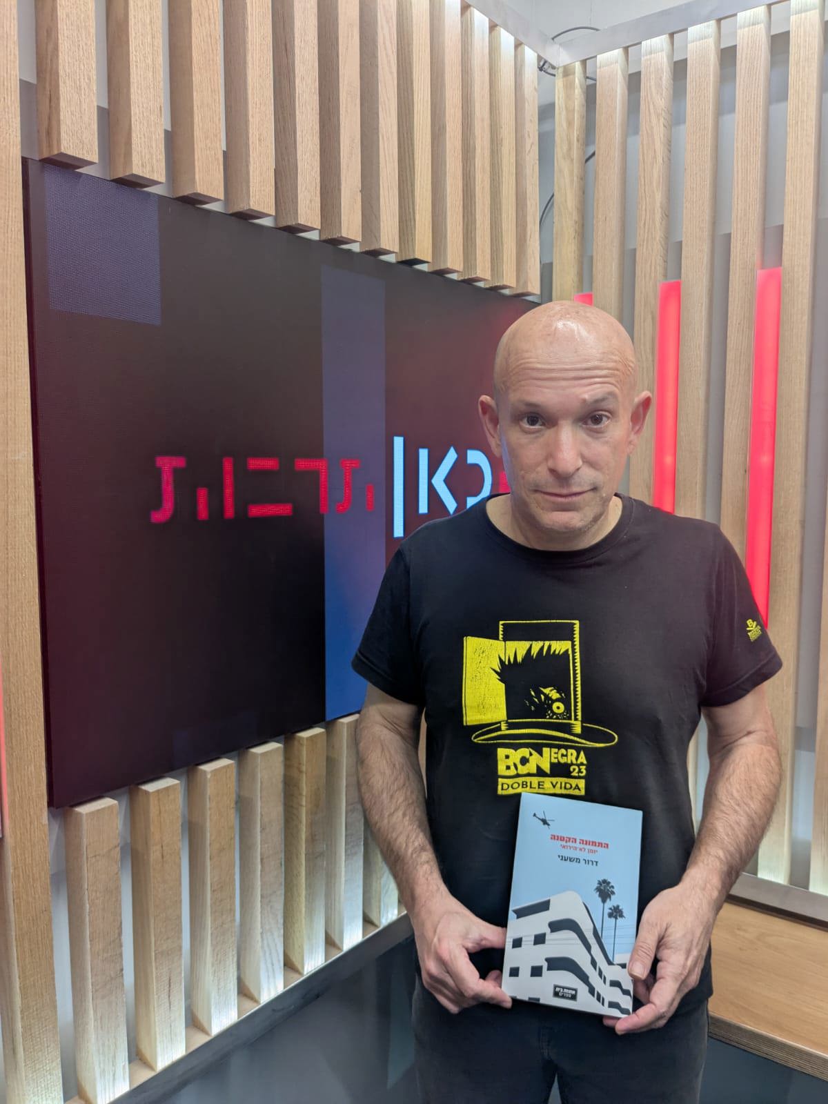 דרור משעני מחזיק את ספרו החדש